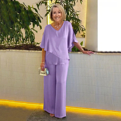 👍2026 Új modell📿Ingyenes gyönyörű nyaklánc🌸Tavaszi női öltöny szett közepes ujjakkal✨Plus size kétrészes alkalmi szett – Fényes luxus anyag, elegáns V-nyakú kialakítás!