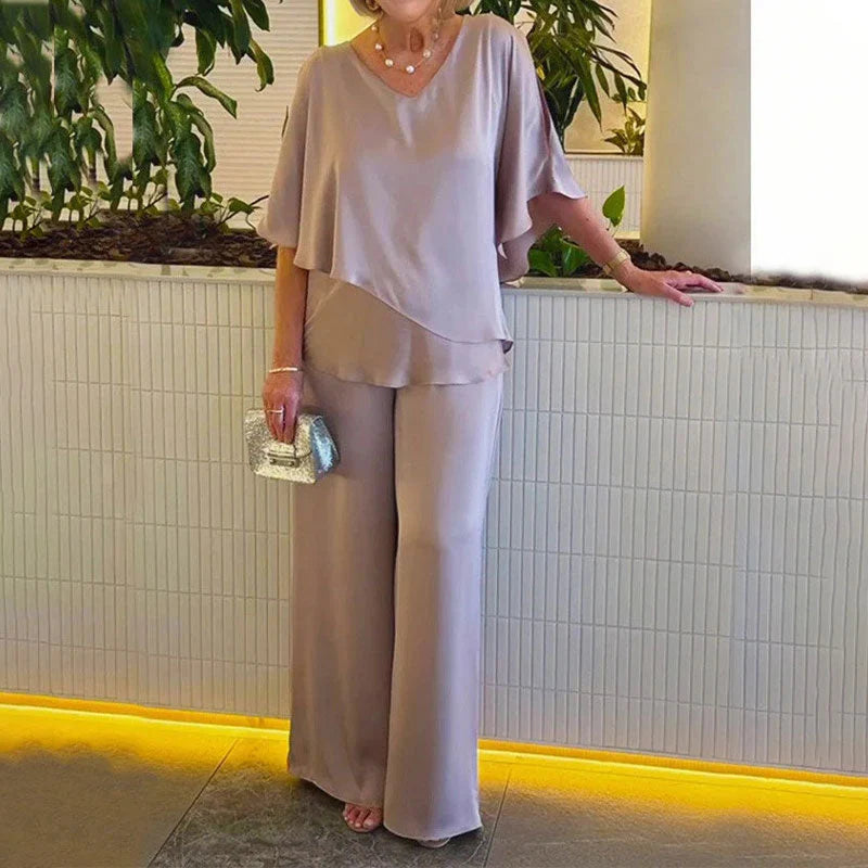 👍2026 Új modell📿Ingyenes gyönyörű nyaklánc🌸Tavaszi női öltöny szett közepes ujjakkal✨Plus size kétrészes alkalmi szett – Fényes luxus anyag, elegáns V-nyakú kialakítás!