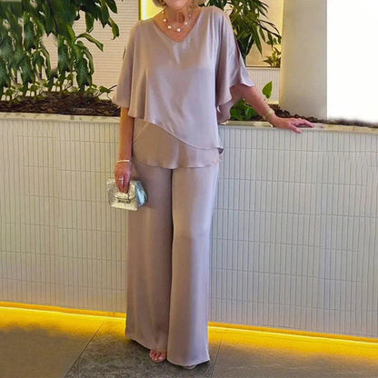 👍2026 Új modell📿Ingyenes gyönyörű nyaklánc🌸Tavaszi női öltöny szett közepes ujjakkal✨Plus size kétrészes alkalmi szett – Fényes luxus anyag, elegáns V-nyakú kialakítás!