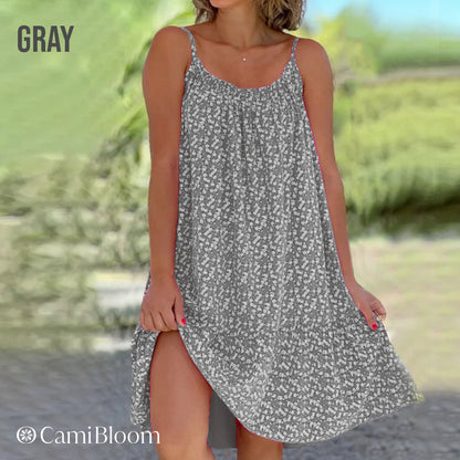 🎁Ingyenes ajándék -📿Gyönyörű nyaklánc🌿 Térdig érő laza camisole ruha🌸 CamiBloom virágmintás spagetti pántos ruha – Jégselyem anyag, állítható pántok, nyári kényelem!